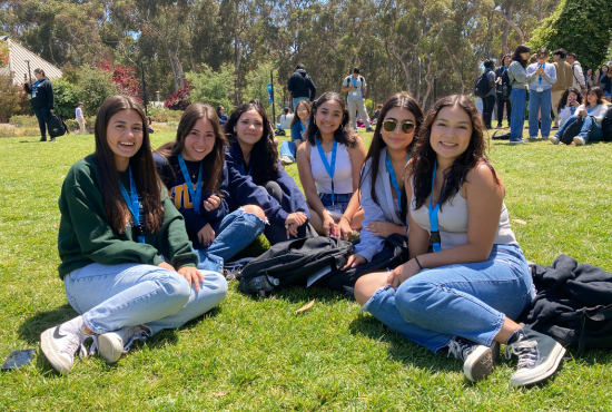 Latinx women picture sitting on the UCSD field